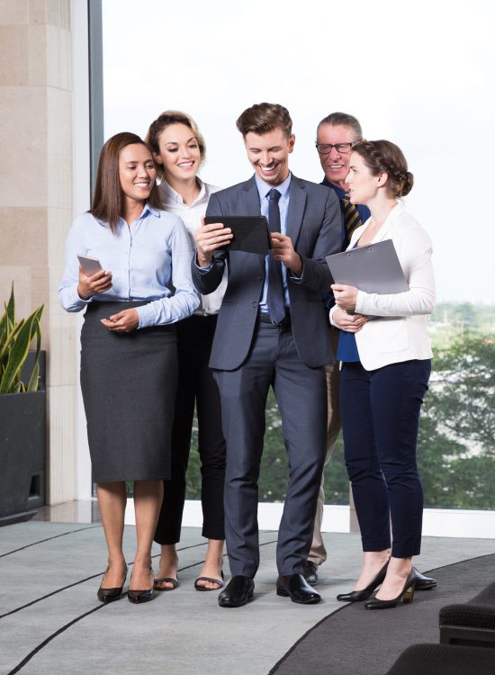 cheerful-business-people-looking-digital-tablet-scaled.jpg